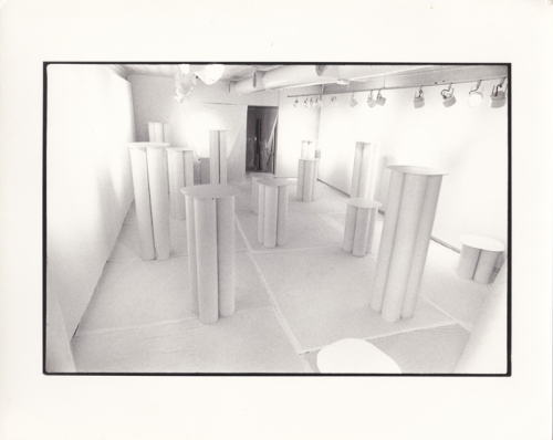 View of 1976 installation: all white walls and floor with white pedestals.